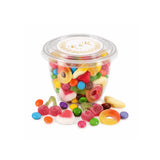 Clear plastic container of colorful gummy candies with white lid featuring gold monogram wreath foiled sticker