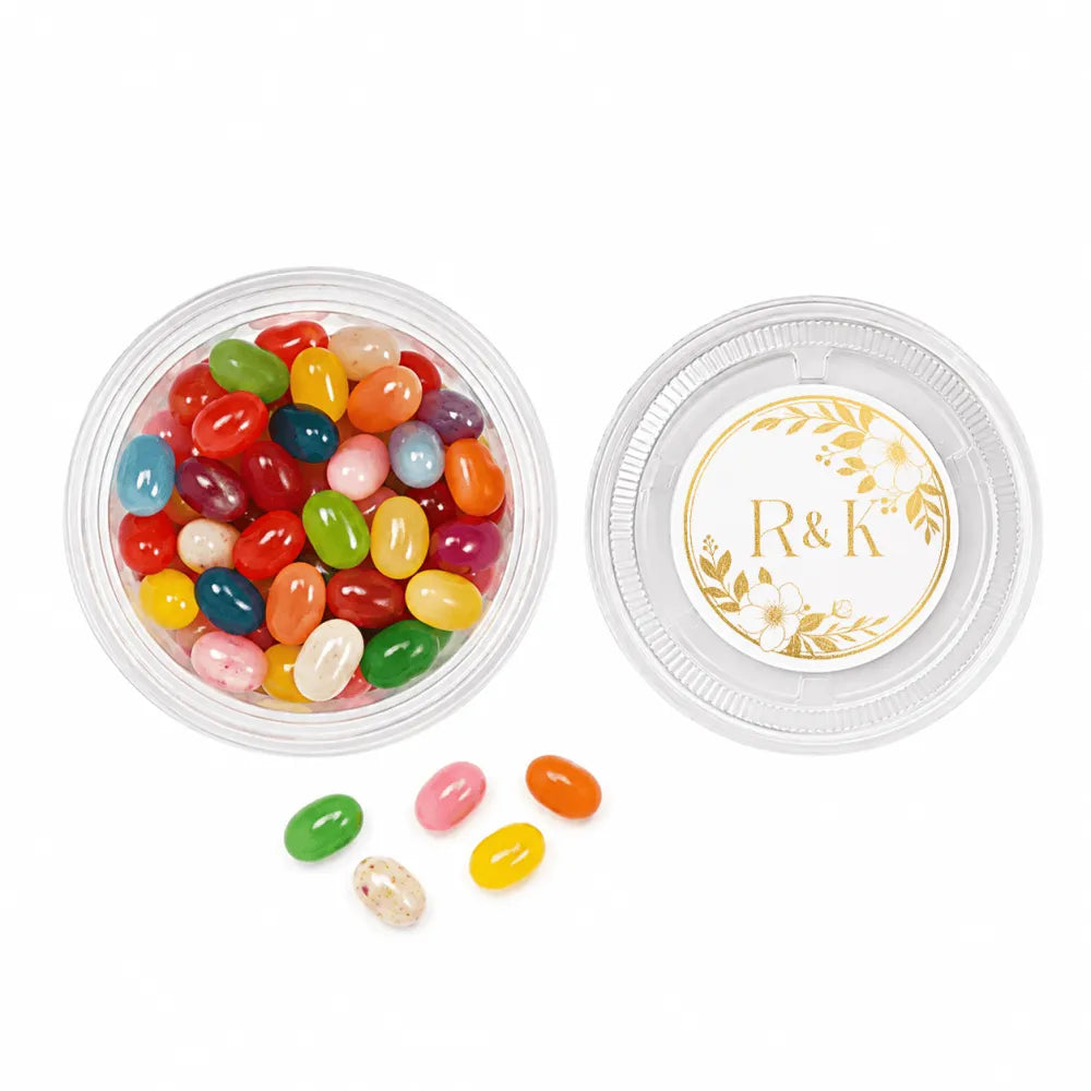 Clear plastic mini tub filled with colorful jelly beans and a gold floral monogram wreath foil sticker lid