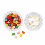Clear plastic mini tub filled with colorful jelly beans and a gold floral monogram wreath foil sticker lid
