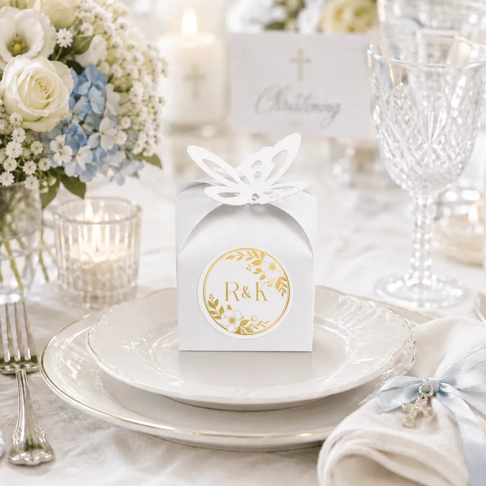 White paper favour box with gold embossed monogram wreath and butterfly cutout perfect for wedding favours