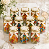 Clear glass jar wedding favours with gold lids cream ribbons and colorful gummies featuring monogram wreath foil sticker
