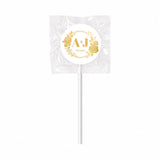 A white monogram wreath foil sticker lollipop wrapped fruit wedding favour with gold sticker and floral design
