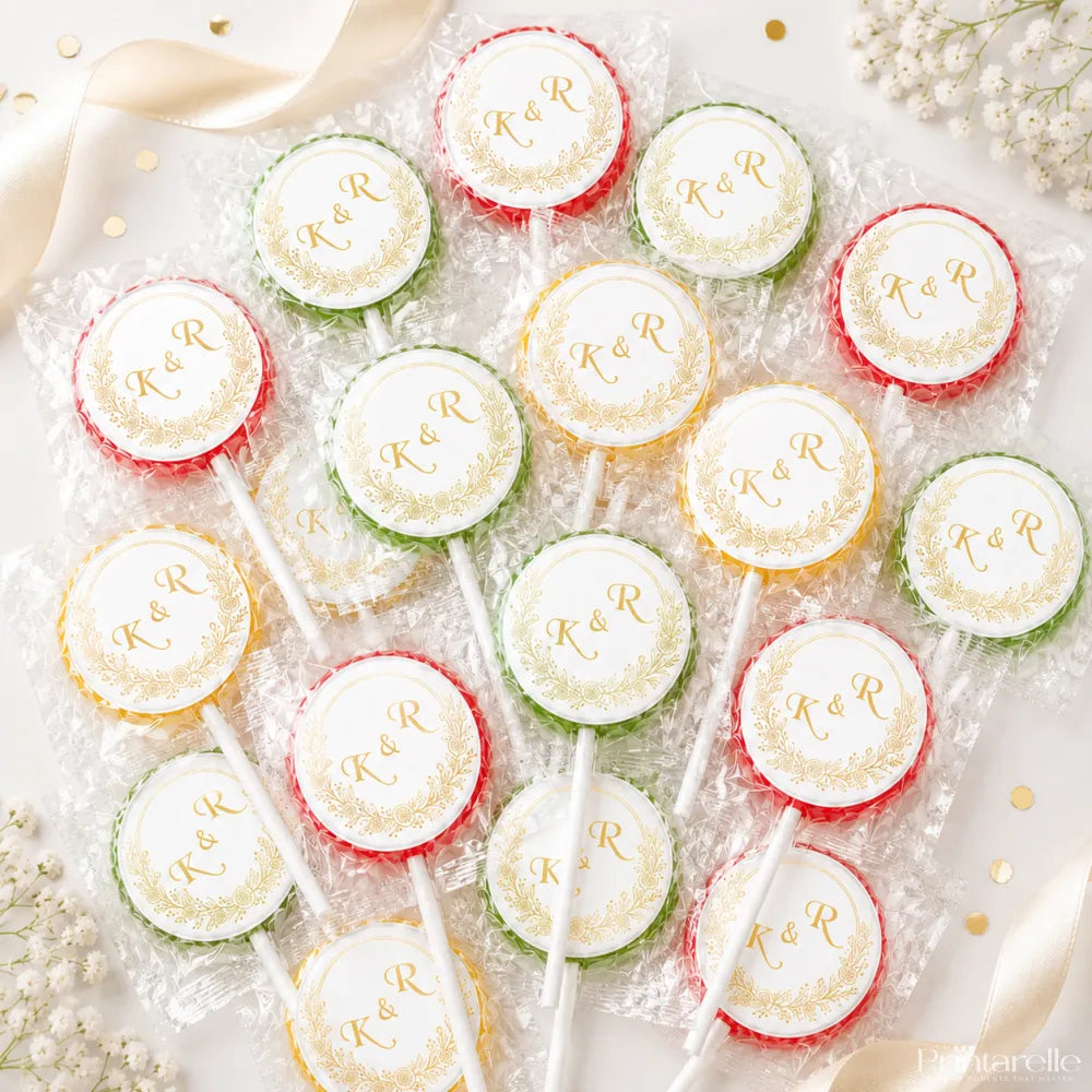 Colorful wrapped fruit lollipops with white gold embossed monogram wreaths perfect for wedding favours