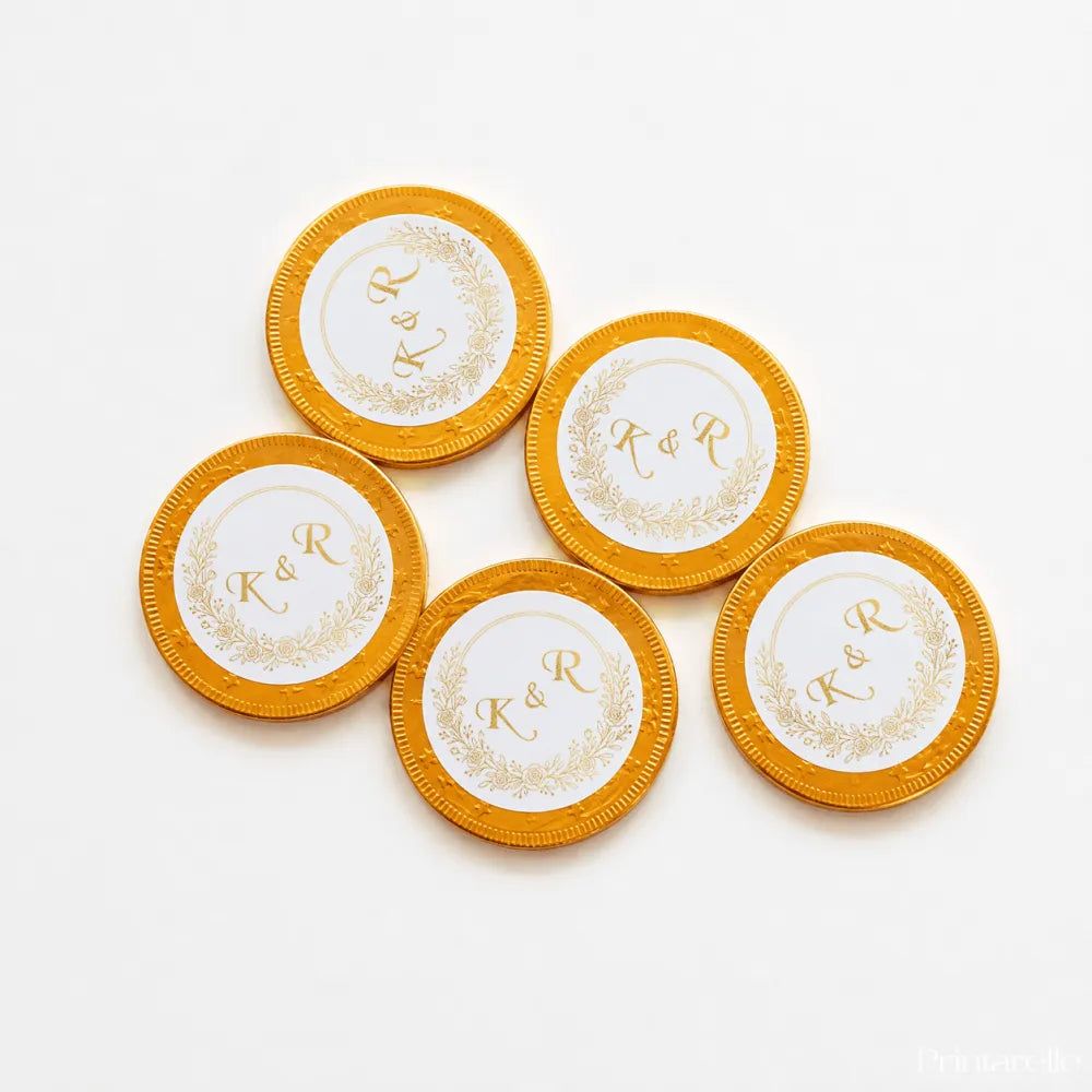 Gold circular 40mm milk chocolate coins with white centers and gold embossed k&r monogram for wedding favours