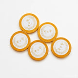 Gold circular 40mm milk chocolate coins with white centers and gold embossed k&r monogram for wedding favours