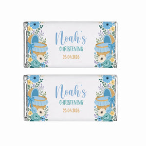 Two personalized 40g blue moses basket chocolate bars wrapped in silver foil with floral baby basket design for christening