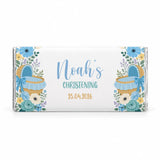 A personalized white chocolate bar with a delicate floral design and blue moses basket for noahs christening
