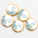 Blue and gold foil wrapped personalised chocolate coins with moses basket and floral accents for christening gifts