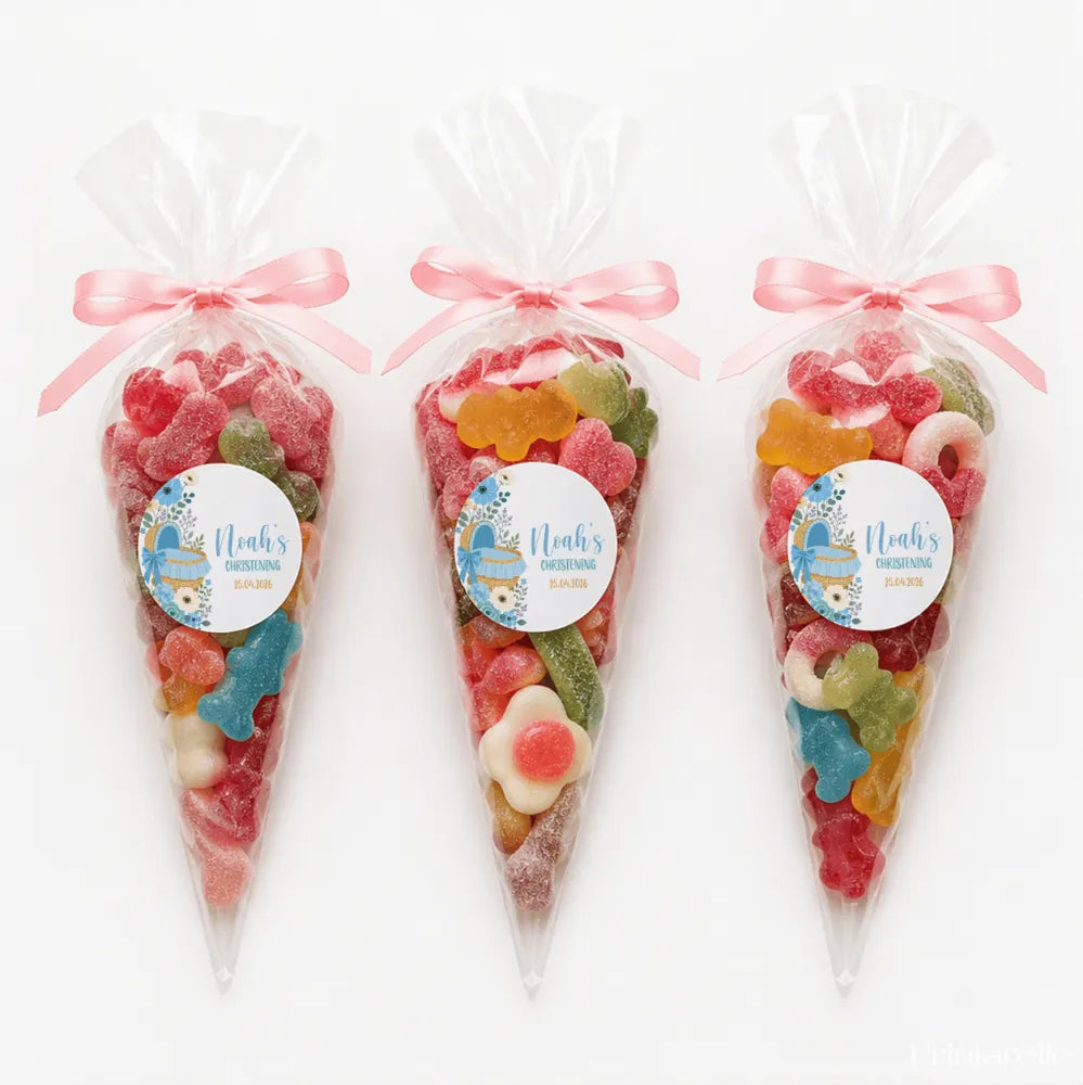 Three clear plastic sweet cones tied with pink ribbons filled with animal gummies for moses basket christening gifts