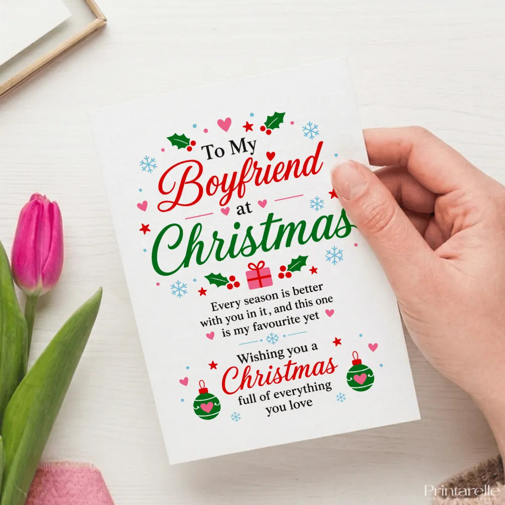A white boyfriend christmas card with festive red green text holly snowflakes and ornaments on 300gsm card