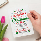 A white boyfriend christmas card with festive red green text holly snowflakes and ornaments on 300gsm card