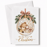 A delicate glass bauble christmas card with a sleeping teddy bear and bunny, decorated with a pink ribbon bow