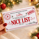 A 135g white chocolate bar wrapped in festive red and gold foil with a nice list design for emily 2026