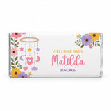 A personalized 40g white chocolate bar wrapped in foil with a nursery mobile floral and baby-themed design