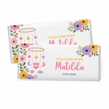 A white chocolate bar wrapped in floral foil personalized with welcome baby matilda and date for nursery mobile 40g chocolate bars
