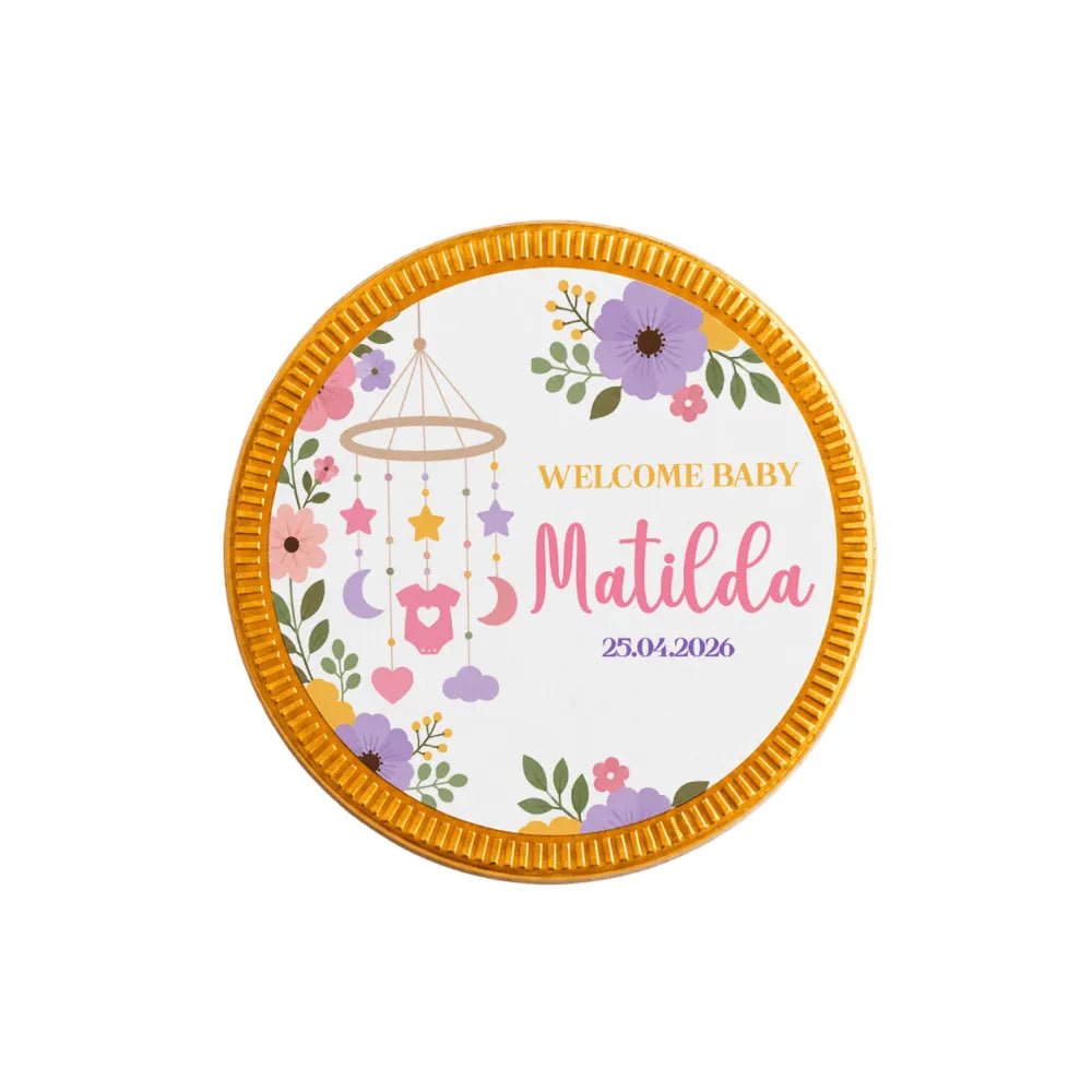 A round gold-edged milk chocolate coin with floral baby design personalized with name matilda and date for nursery mobile