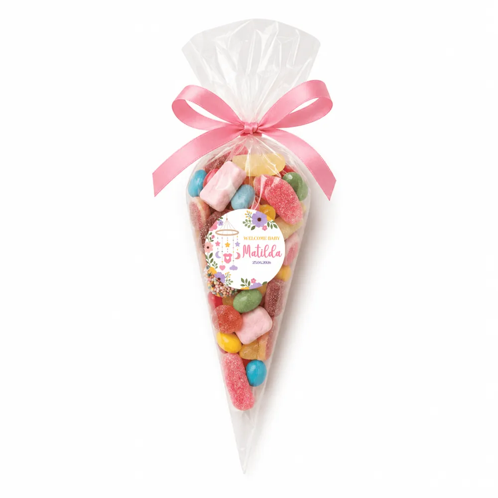 A nursery mobile sweet cone with a pink satin bow filled with colorful marshmallow mix candy in a clear plastic cone