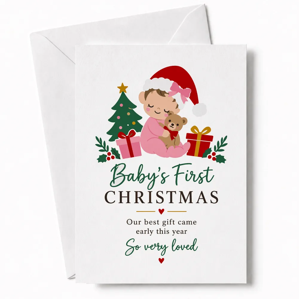 A white christmas card featuring a cartoon baby in pink pajamas and santa hat on 300gsm card titled our best gift came early