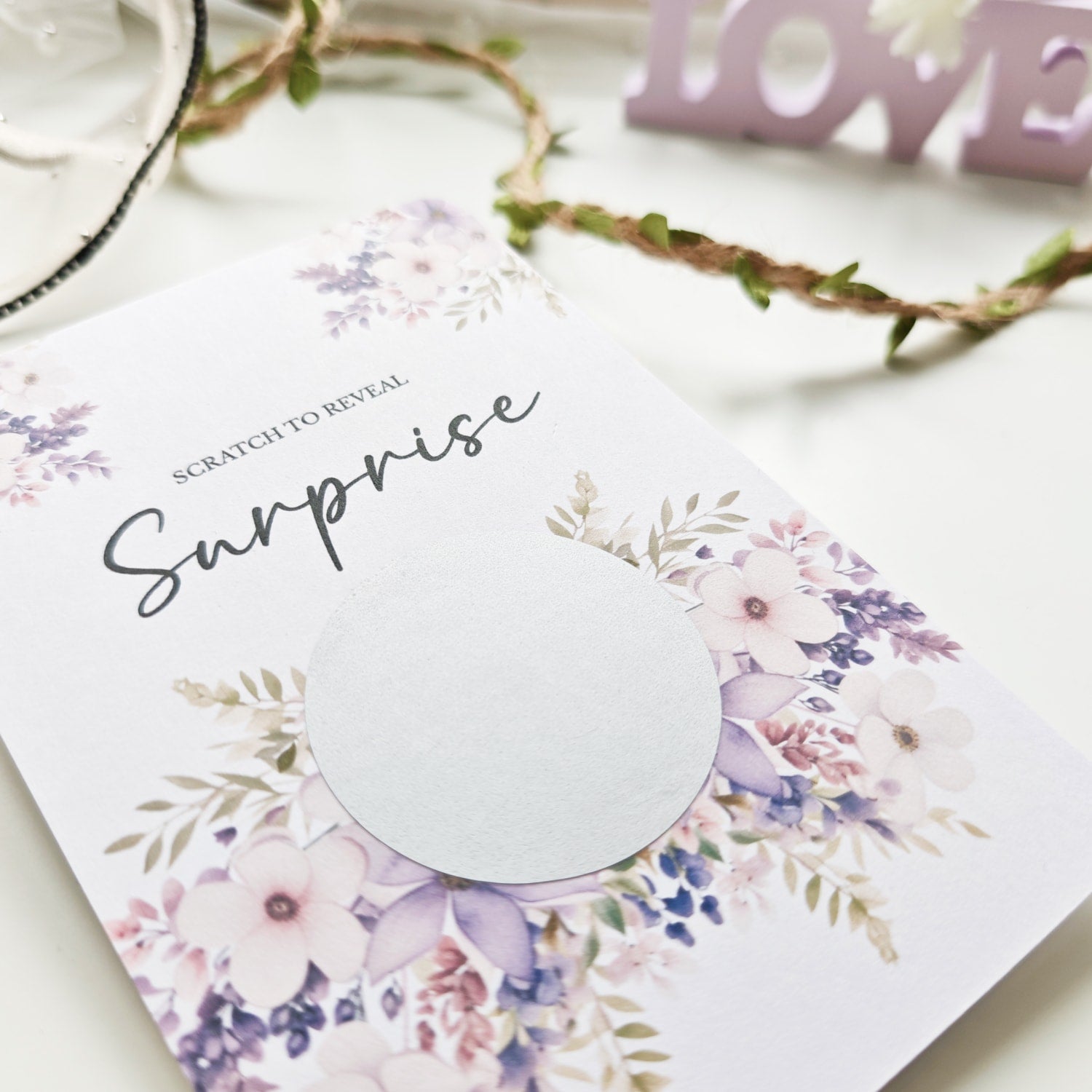 Personalised scratch-to-reveal surprise card with floral design and hidden message for travel, pregnancy, or proposal.