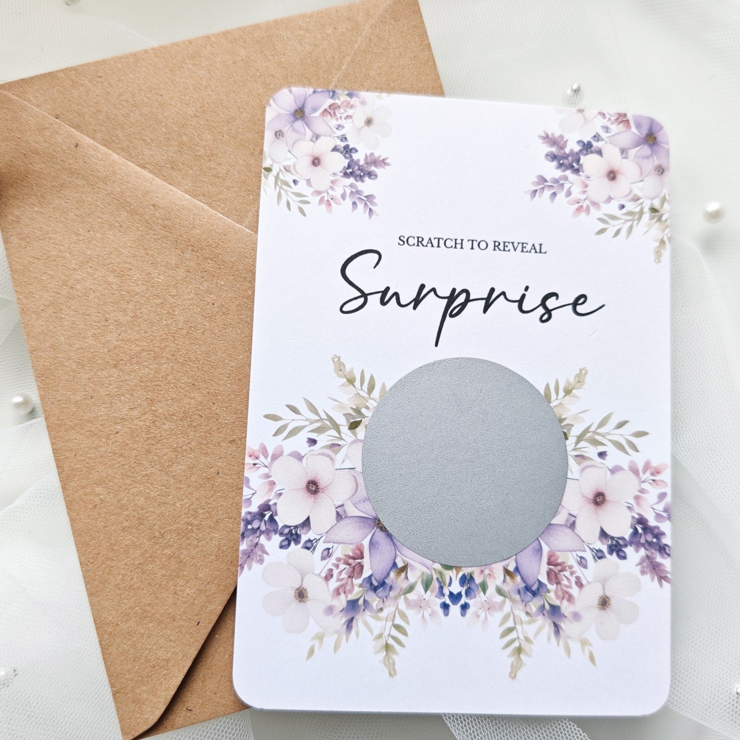 Personalised scratch-to-reveal surprise card with floral design and hidden message for travel, pregnancy, or proposal.