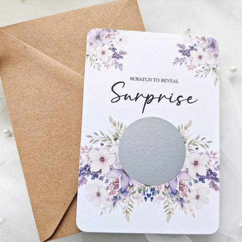 Personalised scratch-to-reveal surprise card with floral design and hidden message for travel, pregnancy, or proposal.