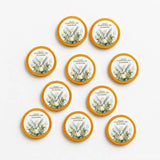 Golden-rimmed confirmation chocolate coins with a white watercolour dove and greenery featuring personal text