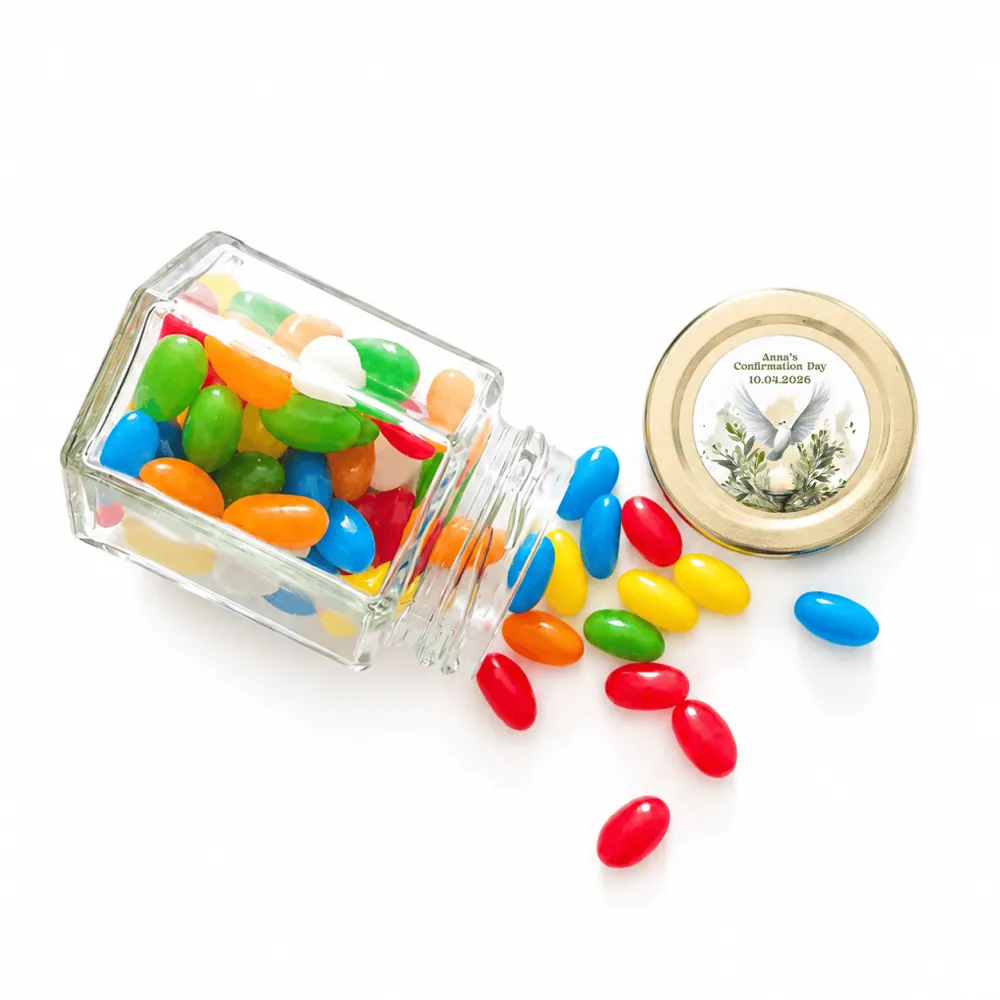 A clear glass hex jar favour with a 48mm pale gold twist lid spills colorful jelly beans for peaceful dove confirmation