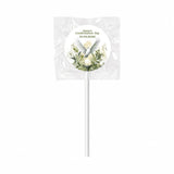 A white lollipop favour wrapped in clear foil with a watercolour dove label for anna’s confirmation day 2026