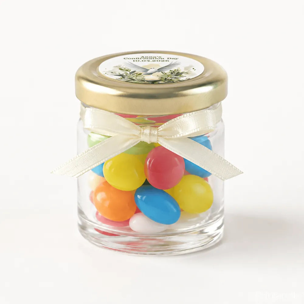 A clear glass jar with a pale gold twist lid and ivory bow filled with colorful jelly beans for peaceful dove confirmation