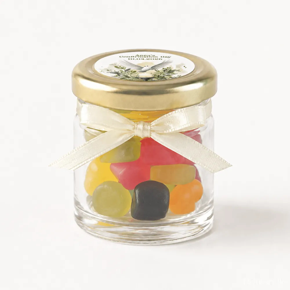 A clear glass mini jar with a gold lid, ivory ribbon bow, and colorful gummies for peaceful dove confirmation gift