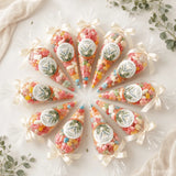 Clear plastic sweet cones filled with colorful gummies tied with cream satin bows and watercolour dove labels for confirmation