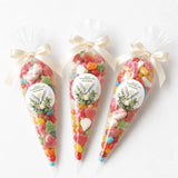 Three clear plastic sweet cones tied with cream satin ribbons and watercolour dove labels for peaceful dove confirmation