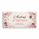 A personalised 40g chocolate bar favour in pink and cream foil with perfume bottles bows and lace decorations