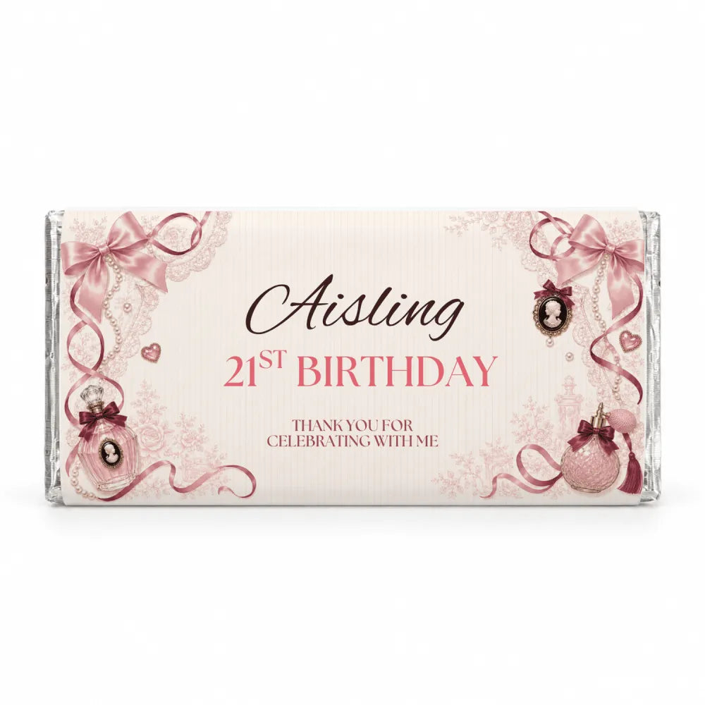 A personalised 40g chocolate bar favour in pink and cream foil with perfume bottles bows and lace decorations