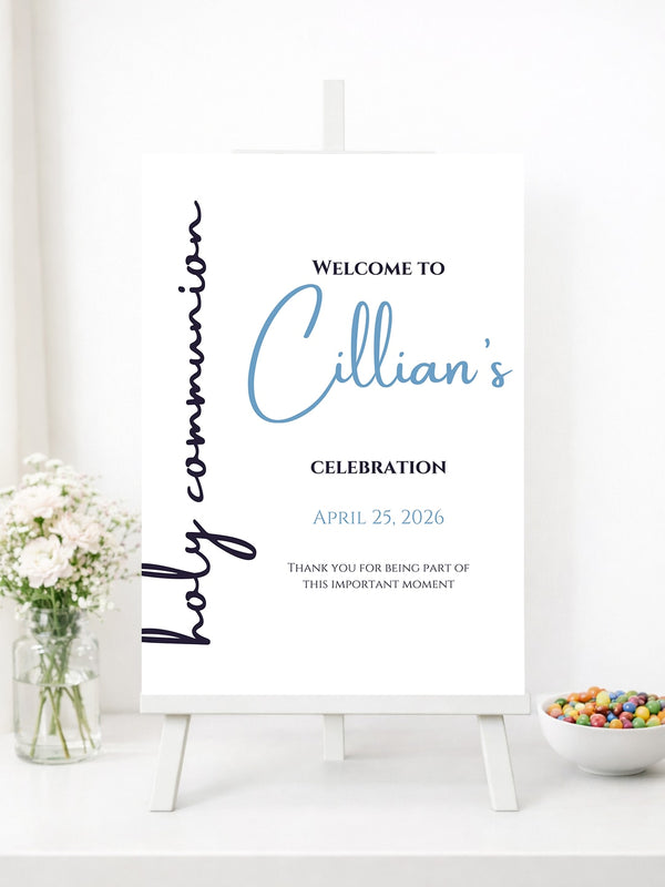 A white welcome sign for holy communion with elegant blue script design in blue and black cursive fonts