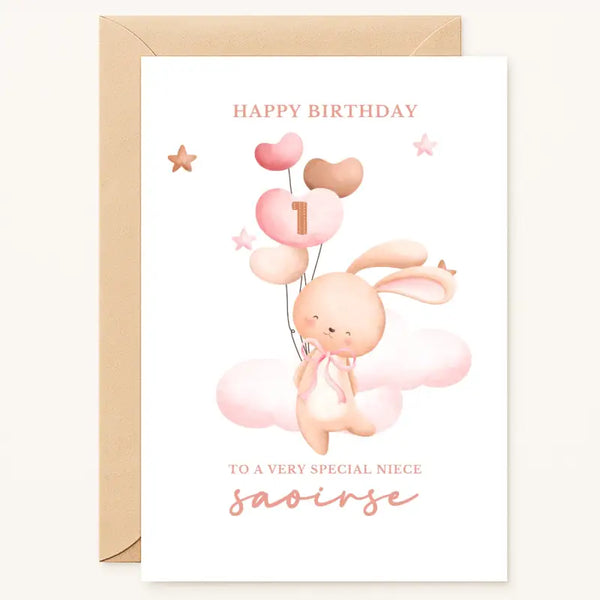 A charming personalised 1st birthday bunny birthday card with a pink bunny floating on clouds holding number 1 balloons perfect for a special niece