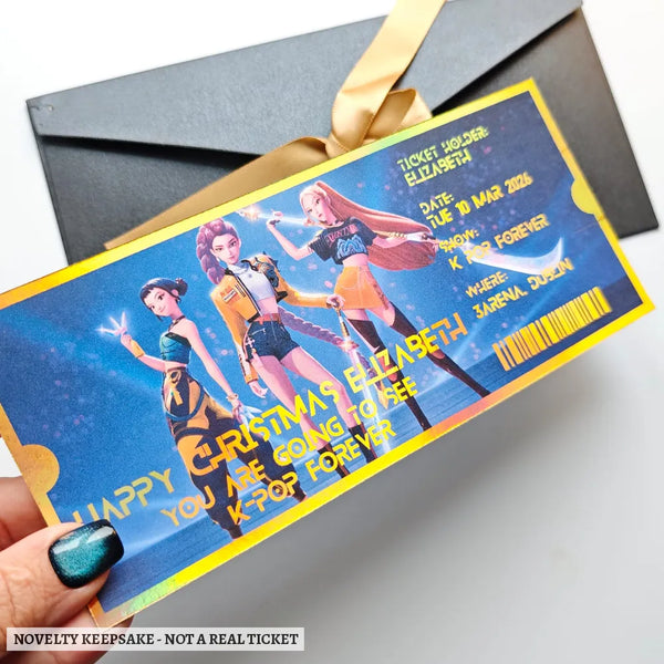 A personalised k-pop concert foil ticket with gold foil finish featuring three animated idols on a blue sparkling background