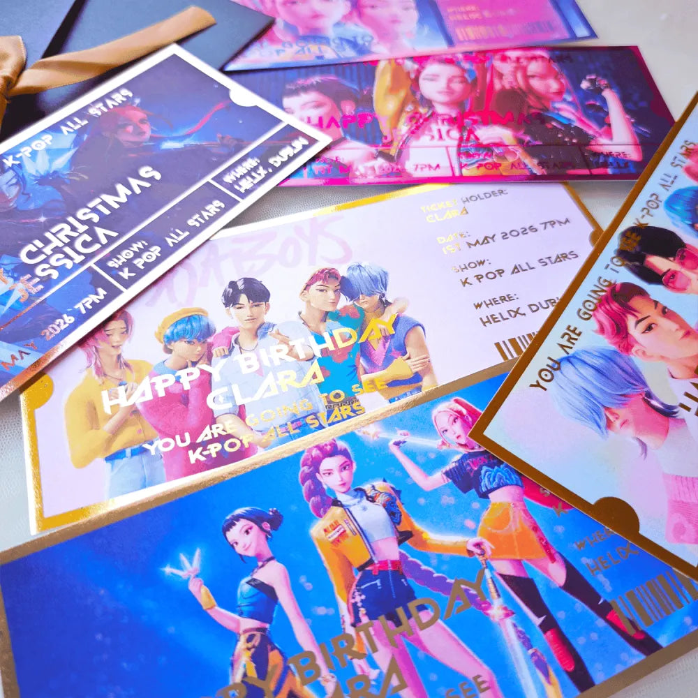 Collection of K-pop themed birthday invitations on a flat surface