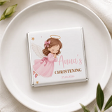 A white chocolate mini neapolitan with a silver foil wrapper featuring a pink angel illustration from pink angel christening
