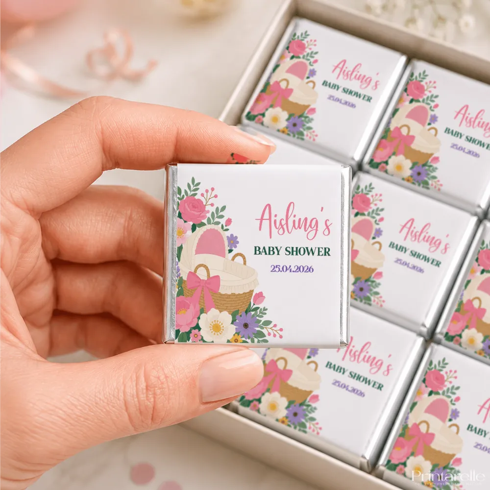 A silver wrapped mini neapolitan chocolates bar with pink and purple floral design for pink bassinet baby shower