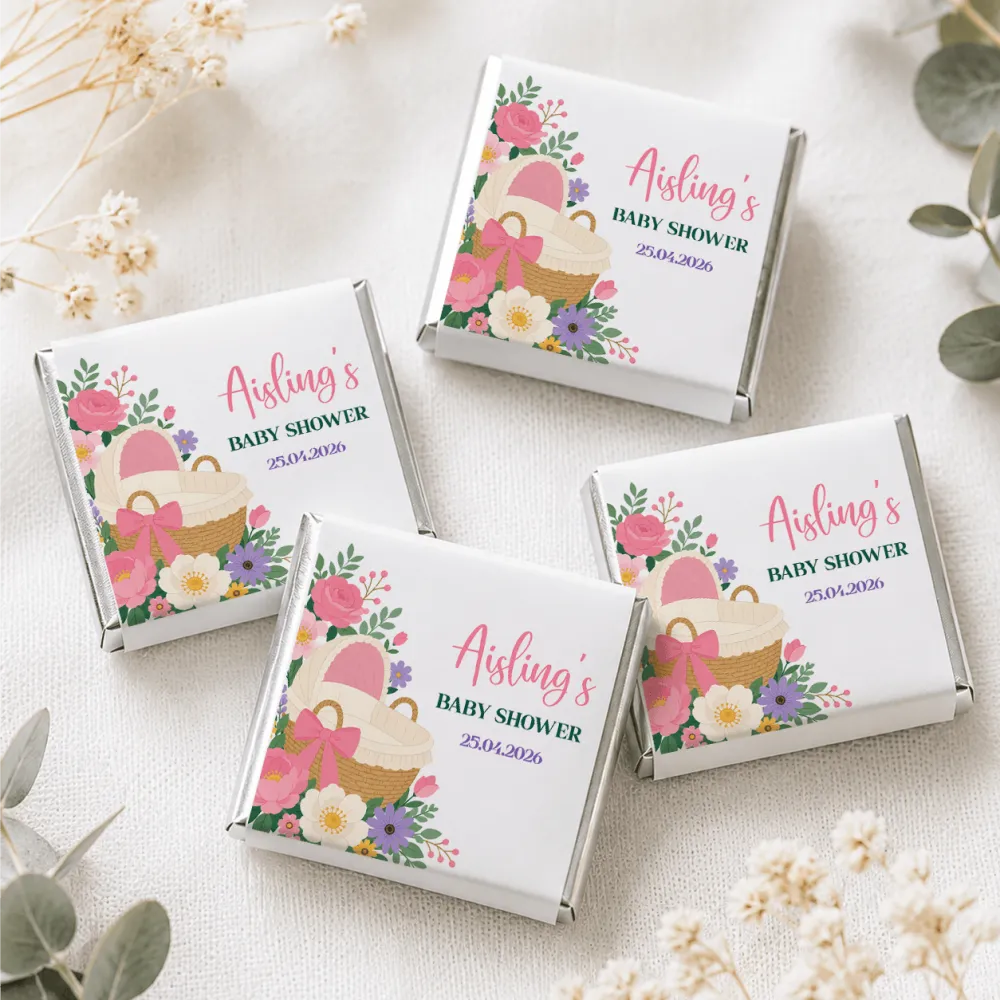 Pink bassinet baby shower white chocolate box with pink purple floral design and baby basket illustration featuring mini neapolitan chocolates