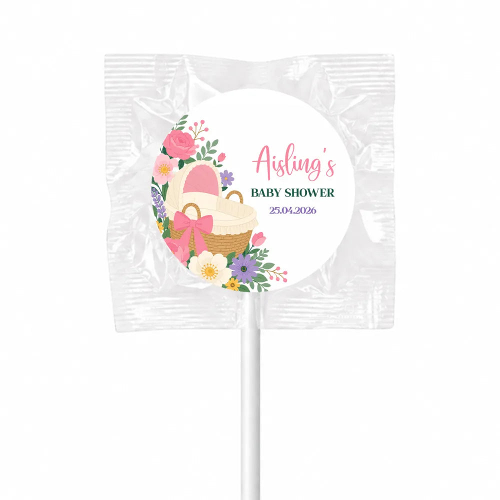 Pink and white floral swirl lollipops finished with wicker basket design wrapped in clear foil for baby shower pink bassinet favors