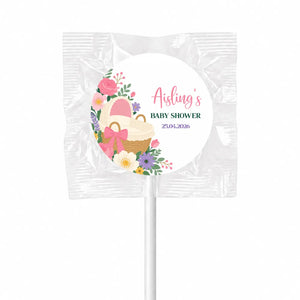 Pink and white floral swirl lollipops finished with wicker basket design wrapped in clear foil for baby shower pink bassinet favors