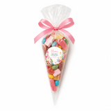 A pink church communion sweet cone with colorful gummies tied with a pink satin ribbon bow