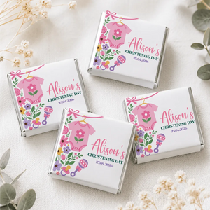 Pink onesie christening mini neapolitan chocolates in white wrappers with floral and baby accessory pink babygrow designs