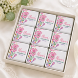 Pink floral themed mini neapolitan chocolates in a white gift box for a pink babygrow christening celebration