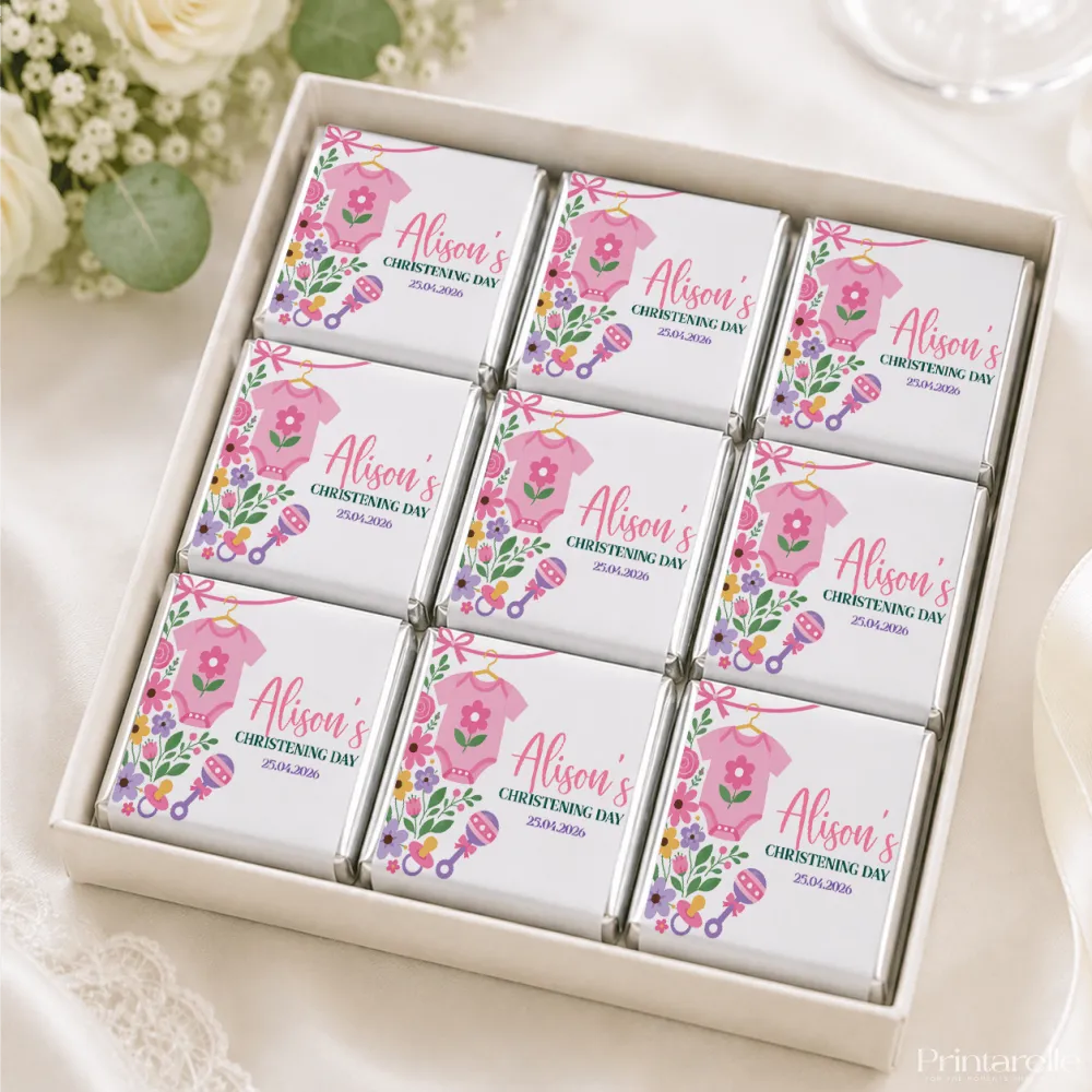 Pink floral themed mini neapolitan chocolates in a white gift box for a pink babygrow christening celebration