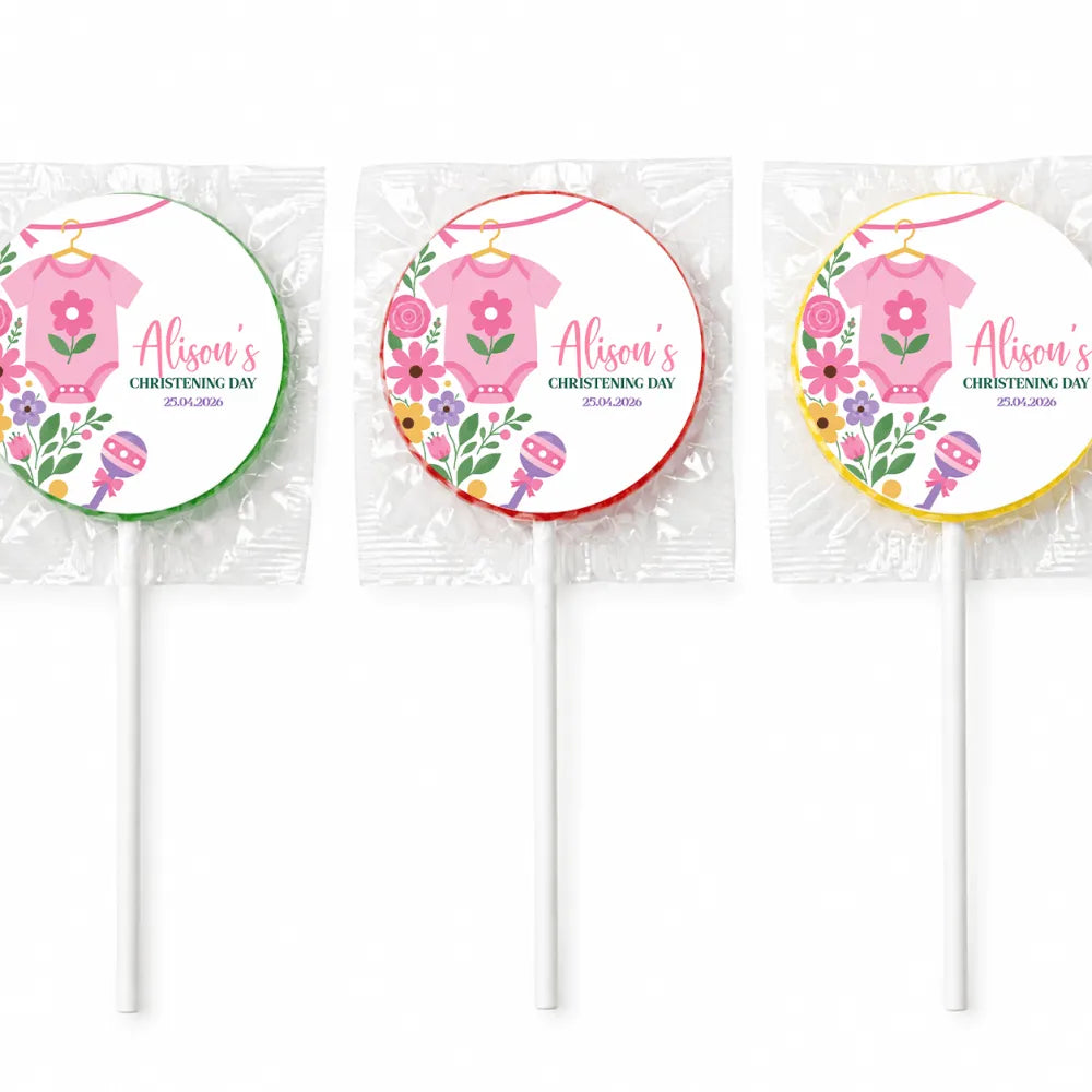 Three personalized pink babygrow lollipop favours wrapped in clear cellophane with colorful floral swirl lollipops finished