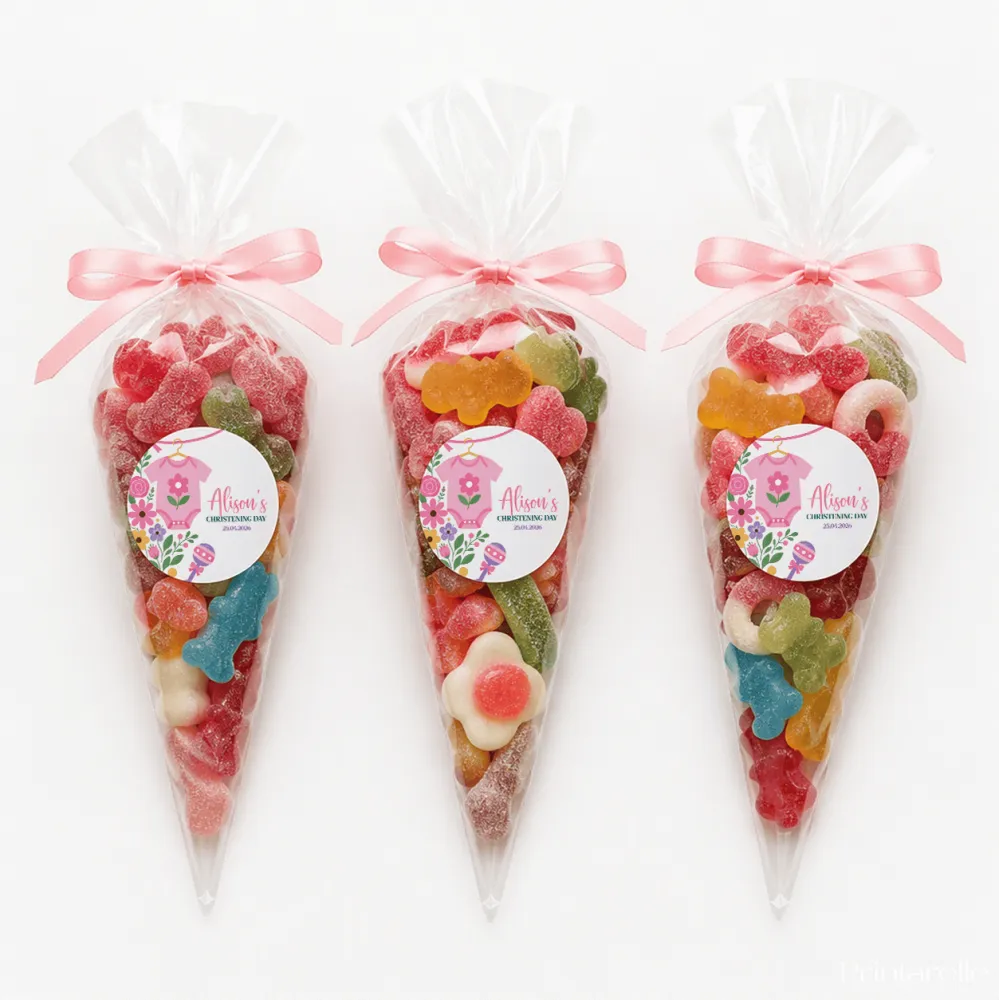 Pink babygrow sweet cones filled with colorful gummy candies tied with pink ribbon and decorated with baby onesie labels