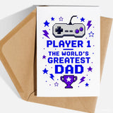White greeting card with pixel art gray and purple game controller and blue text saying player 1 greatest dad for father’s day retro gaming